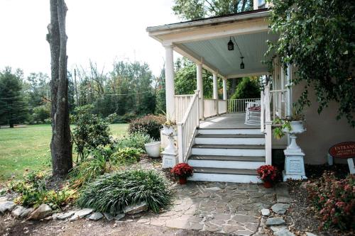 a porch of a house with a white staircase at Charming Accommodation for a Weekend Getaway in Buckingham Township, Pennsylvania in Buckingham