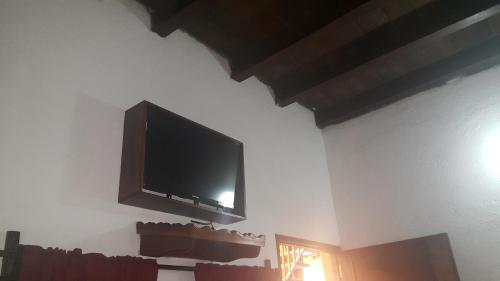 a flat screen tv hanging on a wall at Hotel El Maltese in Granada