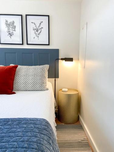 a bedroom with a blue and white bed and a lamp at Pet-Friendly Glamping Cabin, with River Access in Ingram, Texas in Hunt