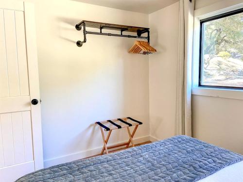 a bedroom with a bed and a window at Pet-Friendly Glamping Cabin, with River Access in Ingram, Texas in Hunt
