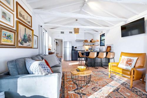 a living room with a couch and a table at Pet-Friendly Glamping Cabin, with River Access in Ingram, Texas in Hunt