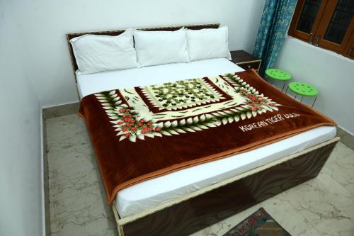 a bed with a blanket on it in a room at maa kalishila home stay in Ukhimath