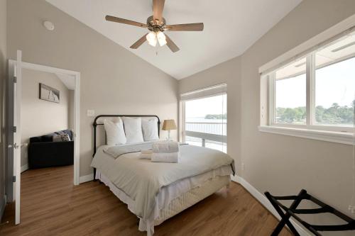 a bedroom with a bed and a ceiling fan at Lighthouse Views & Lake Vibes – 4BR Retreat in Livingston, TX in Blanchard