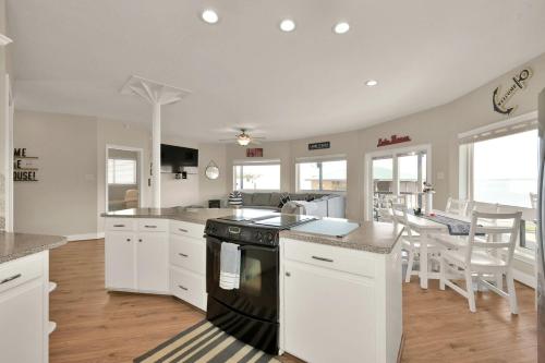 a kitchen with white cabinets and a black stove at Lighthouse Views & Lake Vibes – 4BR Retreat in Livingston, TX in Blanchard