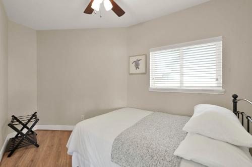 a white bedroom with a bed and a window at Lighthouse Views & Lake Vibes – 4BR Retreat in Livingston, TX in Blanchard