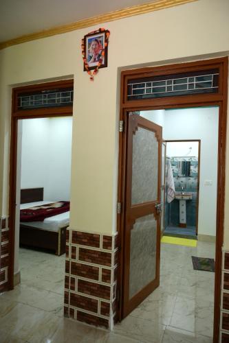 a room with two sliding doors and a bedroom at maa kalishila home stay in Ukhimath