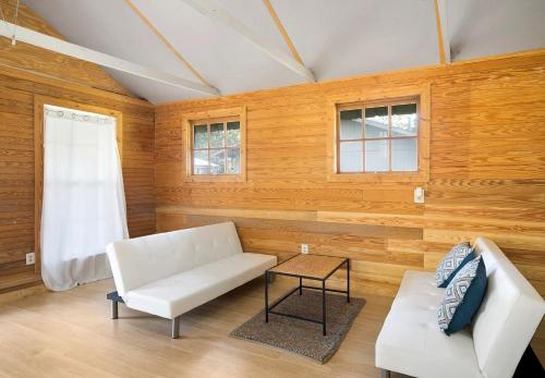 a living room with a white couch and a table at Expansive Vacation Lodge Rental for 60 Guests in Covington, Louisiana in Covington