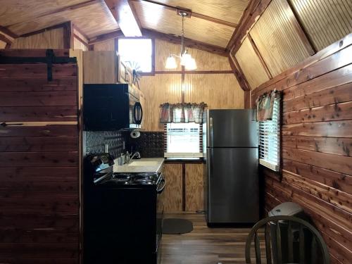 a kitchen with a refrigerator and a stove at Comfortable Cabin Rental on a Winery for a Romantic Getaway in Oklahoma in Allen