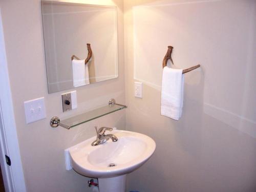 a white bathroom with a sink and a mirror at Mammoth Cave Cabin for the Best Holiday in Kentucky in Mammoth Cave