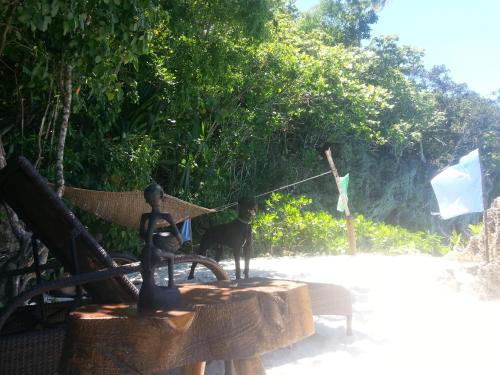 a statue of a man and a cat sitting on a bench at Kim's Garden in Anda