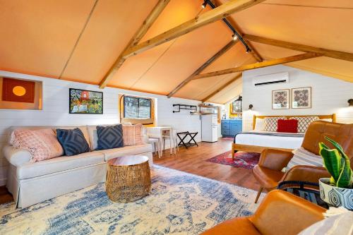 a living room with a couch and a bed at Luxury Cabin, with Hot-Tub Access in Ingram, Texas for Relaxing Weekends Away in Hunt