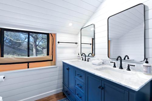 a bathroom with a sink and two mirrors at Luxury Cabin, with Hot-Tub Access in Ingram, Texas for Relaxing Weekends Away in Hunt
