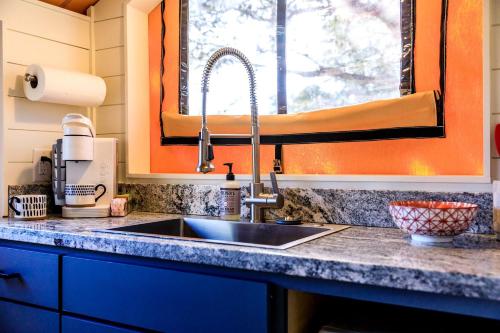 a kitchen counter with a sink and a window at Luxury Cabin, with Hot-Tub Access in Ingram, Texas for Relaxing Weekends Away in Hunt