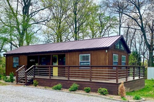 a large wooden cabin with a large deck at Entire Three Cabins Property Perfect for Big Groups in Marion, Illinois in Sunset Harbor