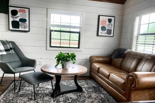 a living room with a couch and a table at Entire Three Cabins Property Perfect for Big Groups in Marion, Illinois in Sunset Harbor