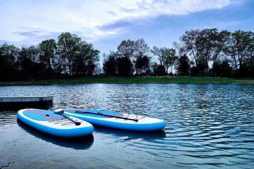 two boats sitting in the water on a lake at Entire Three Cabins Property Perfect for Big Groups in Marion, Illinois in Sunset Harbor