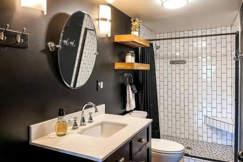 a bathroom with a sink and a toilet and a mirror at Entire Three Cabins Property Perfect for Big Groups in Marion, Illinois in Sunset Harbor
