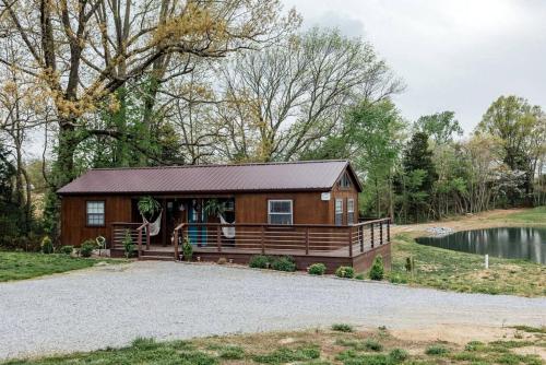 a large wooden cabin with a gravel driveway at Entire Three Cabins Property Perfect for Big Groups in Marion, Illinois in Sunset Harbor