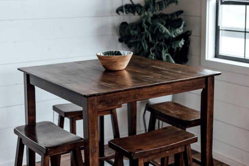 a wooden table with chairs and a bowl on top at Entire Three Cabins Property Perfect for Big Groups in Marion, Illinois in Sunset Harbor