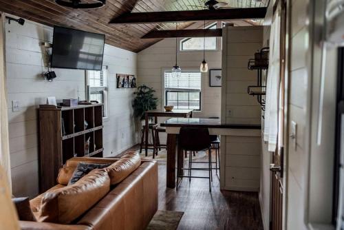 a living room with a couch and a kitchen with a bar at Entire Three Cabins Property Perfect for Big Groups in Marion, Illinois in Sunset Harbor