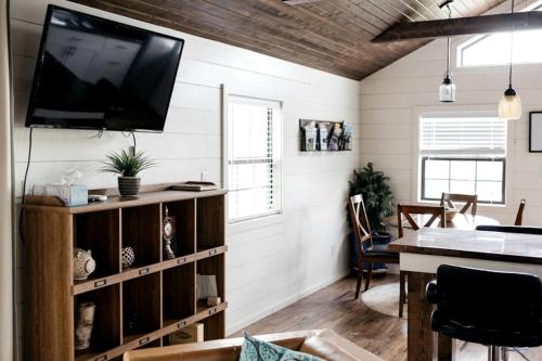 a living room with a flat screen tv on the wall at Entire Three Cabins Property Perfect for Big Groups in Marion, Illinois in Sunset Harbor