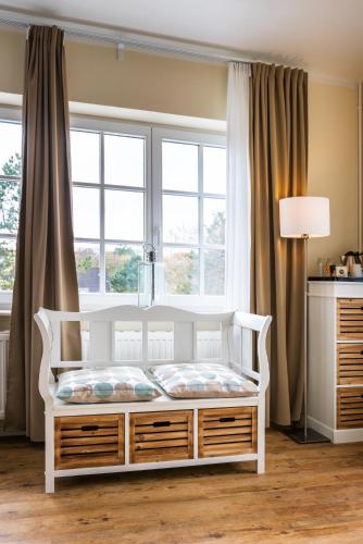 a white bed in a room with a window at Hotel kleine Auszeit - Adults Only in Sankt Peter-Ording