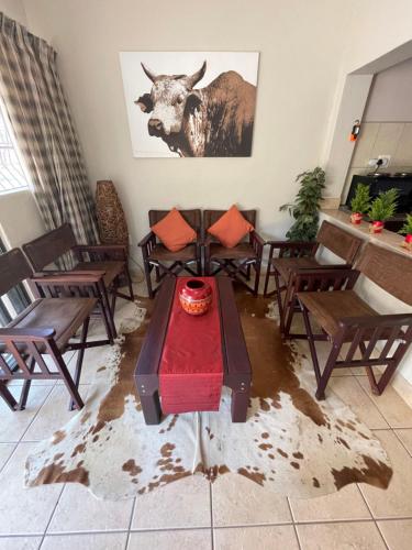 a room with chairs and a table with a cake on it at Bush Lovers Lodge in Modimolle