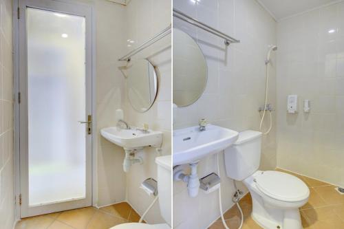 a white bathroom with a toilet and a sink at Capital O 94792 Aleander Hotel in Jakarta