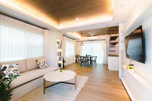 a living room with a couch and a table at Beautiful private house