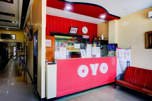 a store with a red and white sign on a counter at OYO 94787 Hotel Mulana in Banda Aceh