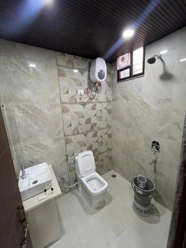 a bathroom with a toilet and a sink at Sukoon Grandeur in Jāmb