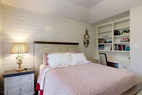 a bedroom with a bed and a table with a lamp at Charming Remodeled Home with Modern Comforts Near TAMU & Downtown in Bryan, Texas in Bryan