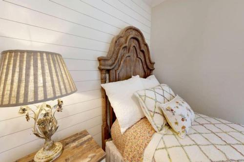 a bedroom with a bed with a lamp on a table at Charming Remodeled Home with Modern Comforts Near TAMU & Downtown in Bryan, Texas in Bryan