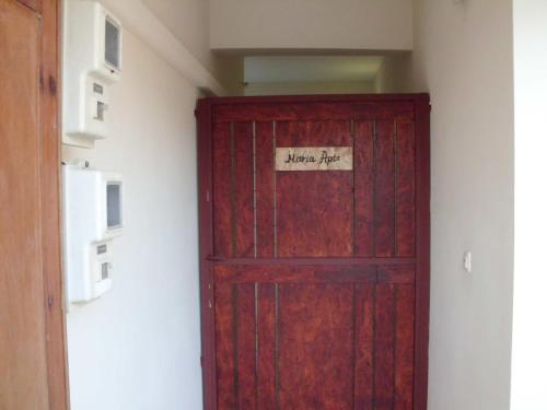 a red door with a sign on it in a room at Maria Apts in Istron