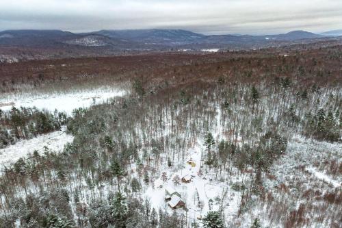 an aerial view of a forest with snow and trees at Cozy Log Cabin with an Indoor Fireplace Located on 70 Forested Acres in Leicester, Vermont in Leicester