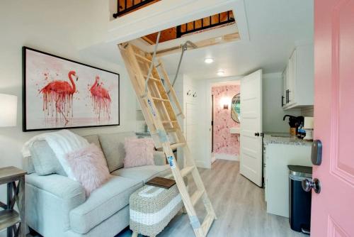 a living room with a couch and a loft bed at Colorful Tiny House with Outdoor Sauna and Jacuzzi in Alabama in Grant