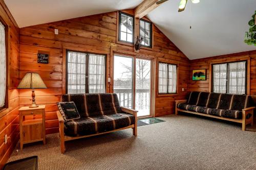 a living room with two chairs and a table at Stunning Cabin Getaway Surrounded by Towering Pine Trees in Walker, Minnesota in Ah-gwah-ching