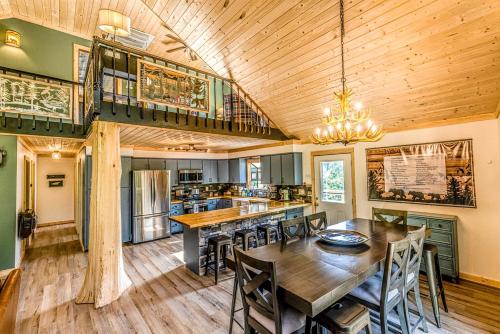 a kitchen with a large wooden table and chairs at Incredible Mountain Cabin with Private Creek and Hot Tub Allowing Outstanding Views in Bryson City in Franklin Grove