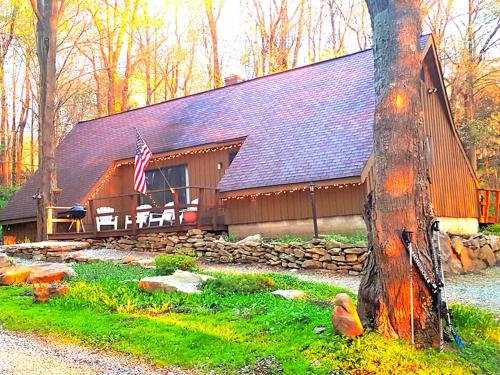 a barn with an american flag in front of it at Charmingly Rustic Weekend Getaway in the Mountains near Pittsburgh, Pennsylvania in Champion