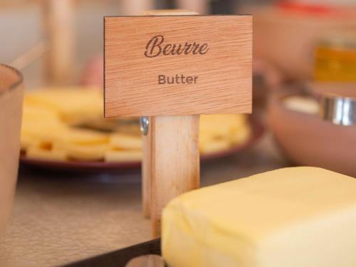 a sign that reads beine butter sitting on top of cheese at Mercure Nice Centre Notre Dame in Nice