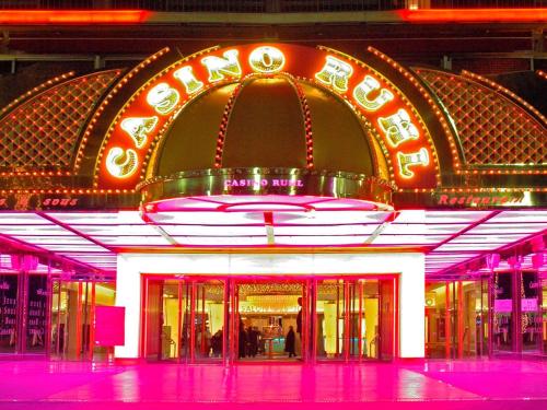 a lit up building with a neon sign on it at Mercure Nice Centre Notre Dame in Nice