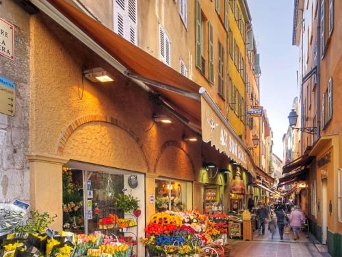a street with a flower shop in a city at Mercure Nice Centre Notre Dame in Nice