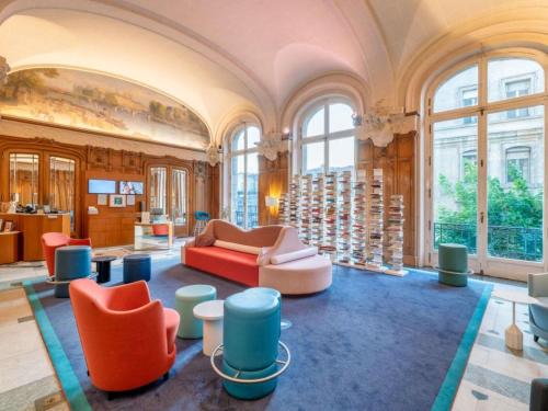 a large room with chairs and tables and windows at Mercure Lyon Centre Château Perrache in Lyon