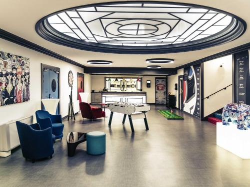 a room with a table and chairs and a ceiling at Mercure Lyon Centre Château Perrache in Lyon