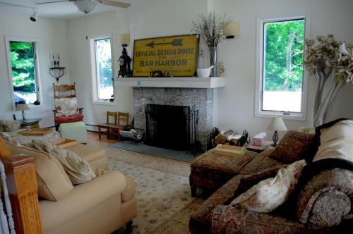 a living room with a couch and a fireplace at Impressive Cabin with a Pool and Hot Tub Ideal for Weekend Getaways in the Catskills in Tannersville