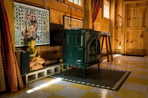 a green stove in a room with a wall at Tranquil Yurt Rental for Two with Soothing Interior on Ranch near San Luis Obispo in Cayucos