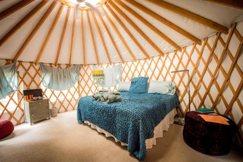 a bedroom with a bed in a yurt at Tranquil Yurt Rental for Two with Soothing Interior on Ranch near San Luis Obispo in Cayucos