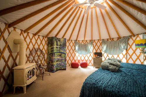 a bedroom with a tent with a bed in it at Tranquil Yurt Rental for Two with Soothing Interior on Ranch near San Luis Obispo in Cayucos