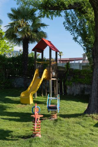 a playground with a slide in the grass at Seegarten in Caldaro