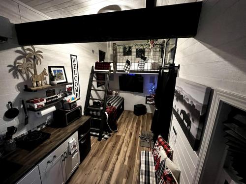 a room with a loft bed in a house at Remote Modern Tiny House with Deck, BBQ and Mountain Views in Arizona in Maricopa